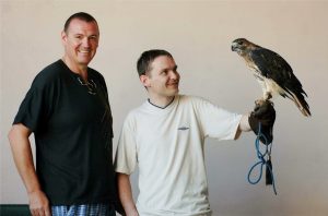 Two young men with a bird of prey
