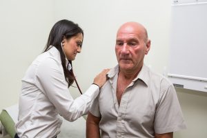 Dr listening to patient's chest