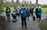 Volunteer Doalty leads a group of walkers in a Glasgow park.