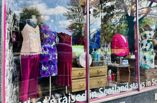 A window display of ladies clothes and accessories.